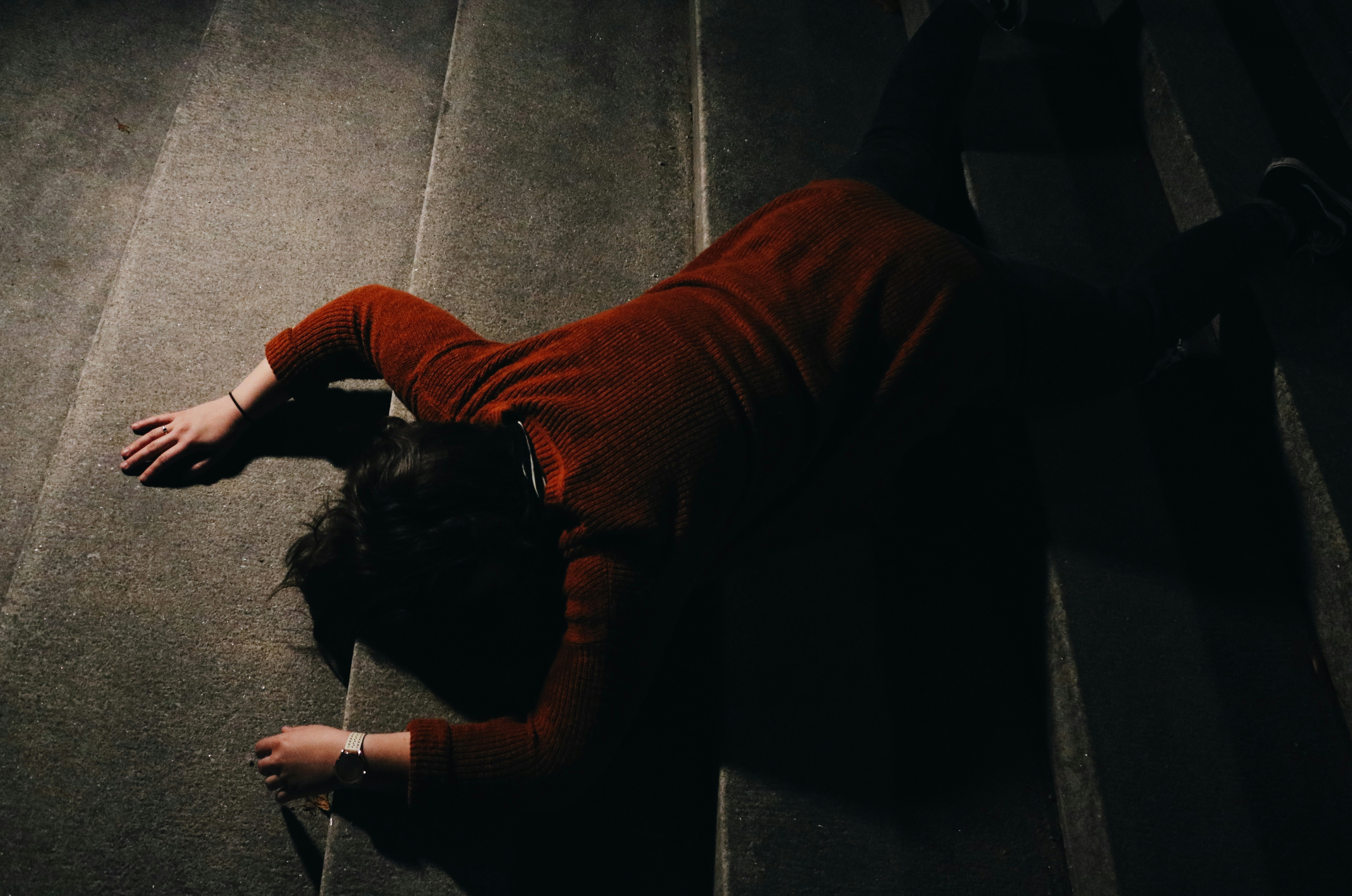 woman lying on stairway at nighttime